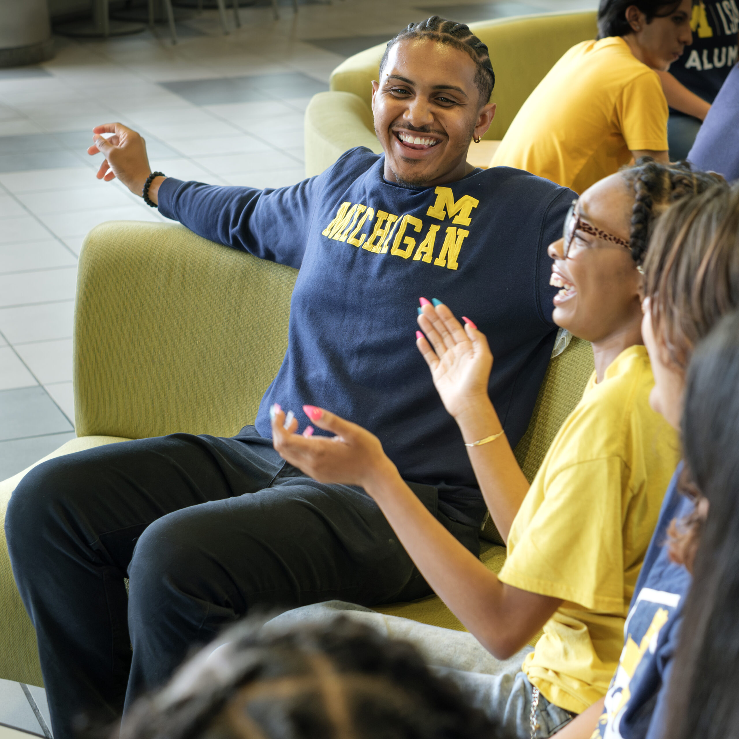 people sitting on couch smiling and clapping